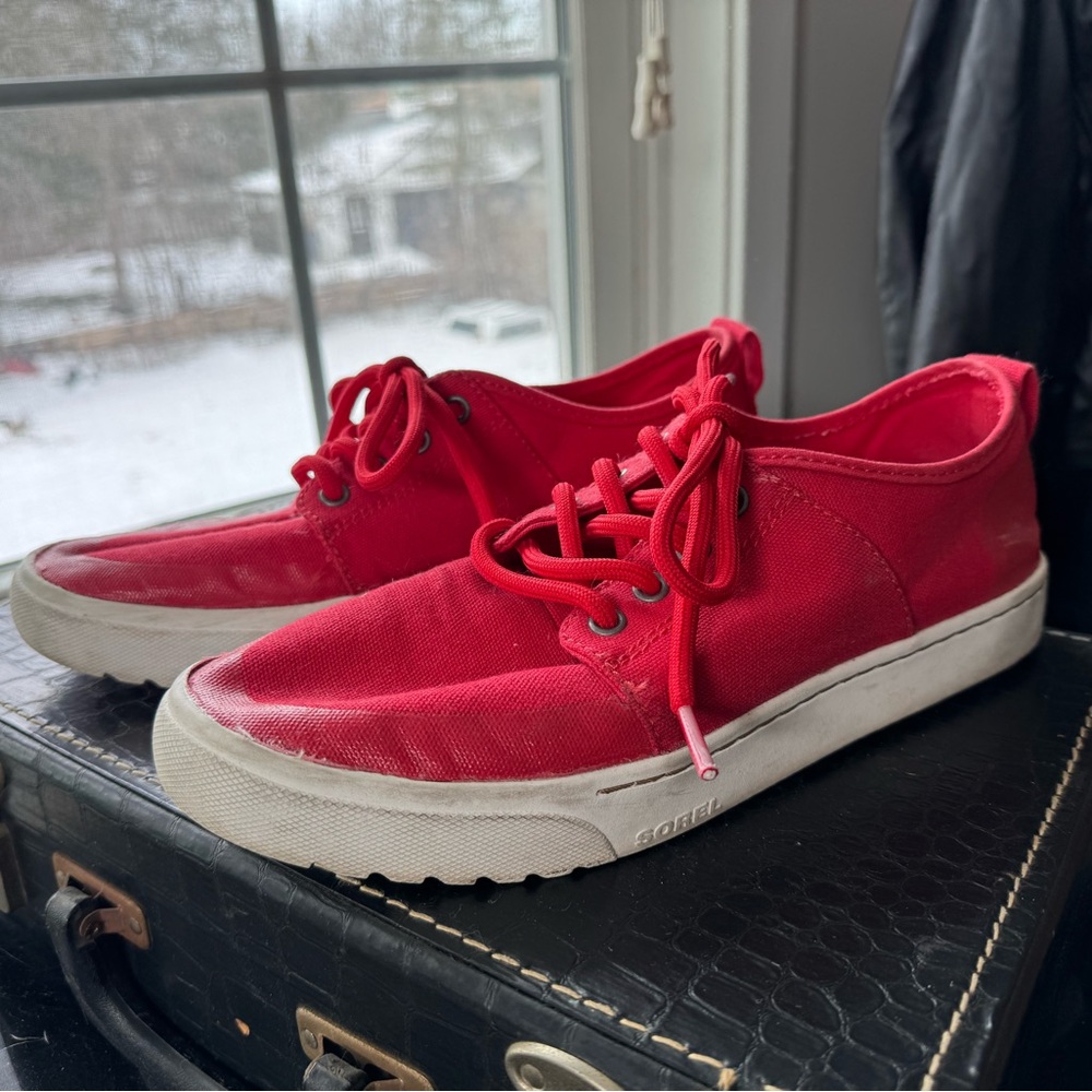 Sorel red canvas sneakers with white soles.